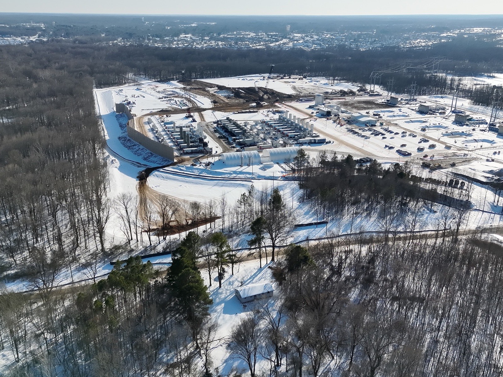 Aerial photograph of Krystal Polk's home in the foreground, directly across the street from xAI's gas plant in Southaven, Mississippi.